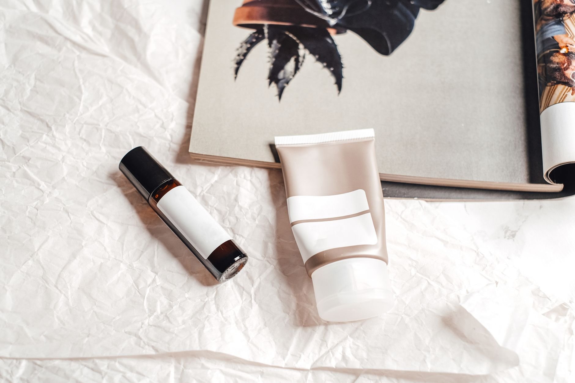 Flat lay of skincare products on textured paper — editorial product photography for beauty brands